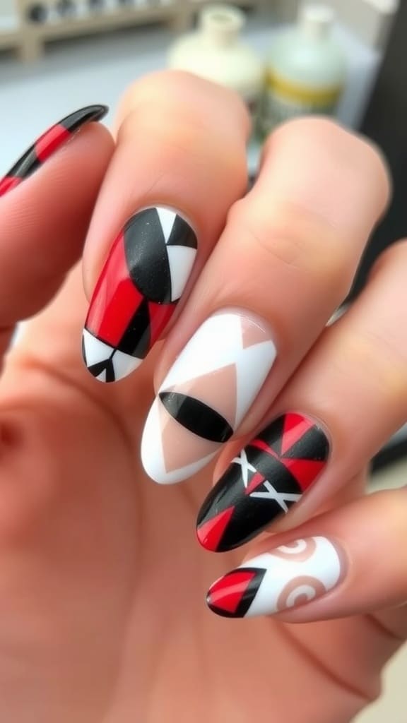 Almond nails featuring geometric designs in red, black, and white
